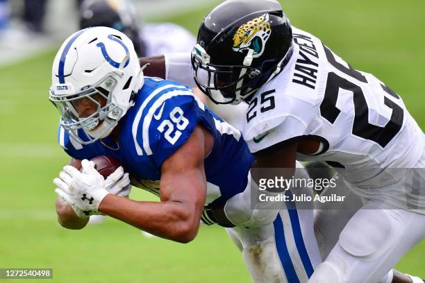Jonathan Taylor of the Indianapolis Colts is brought down by D.J. Hayden of the Jacksonville Jaguars during the fourth quarter at TIAA Bank Field on...