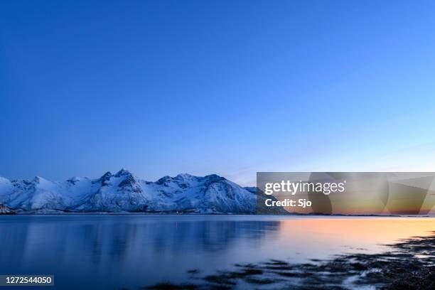 snowy winter landscape sunset in the lofoten in norway - fjord stock pictures, royalty-free photos & images