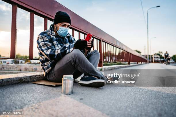 beggar using phone - homeless person stock pictures, royalty-free photos & images