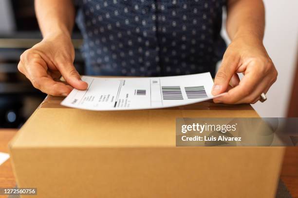 woman preparing package for online delivery - shipping package stock pictures, royalty-free photos & images