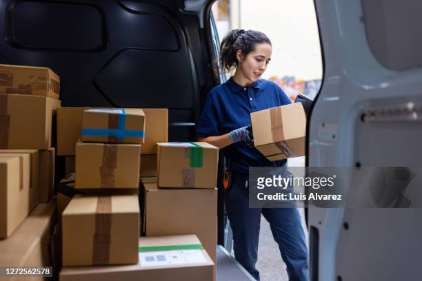 courier checking the parcel for delivery - freight transportation stock-fotos und bilder