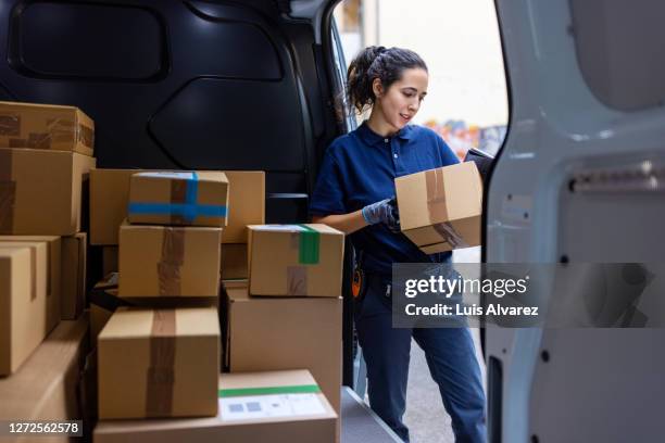 courier checking the parcel for delivery - mensajero fotografías e imágenes de stock