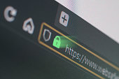 Dark web browser close-up on LCD screen with shallow focus on https padlock