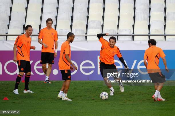 Frank Lampard of Chelsea tackles team mate Jose Bosingwa as John Terry , Fernando Torres and Juan Mata look on during a training session ahead of the...