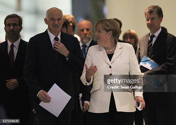 German Chancellor Angela Merkel and Greek Prime Minister George Papandreou arrive to speak to the media prior to talks at the Chancellery on...