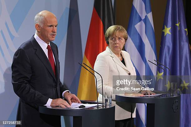 German Chancellor Angela Merkel and Greek Prime Minister George Papandreou speak to the media prior to talks at the Chancellery on September 27, 2011...