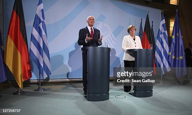 German Chancellor Angela Merkel and Greek Prime Minister George Papandreou speak to the media prior to talks at the Chancellery on September 27, 2011...
