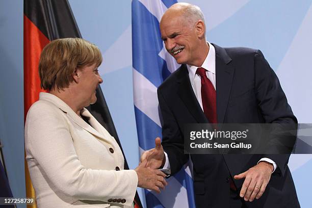 German Chancellor Angela Merkel and Greek Prime Minister George Papandreou depart after speaking to the media prior to talks at the Chancellery on...