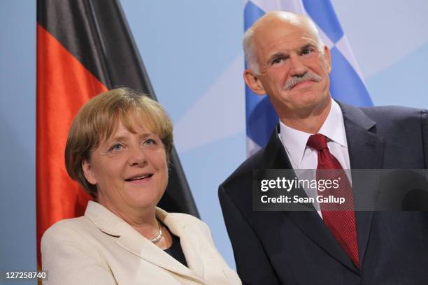 German Chancellor Angela Merkel and Greek Prime Minister George Papandreou depart after speaking to the media prior to talks at the Chancellery on...