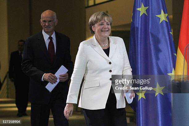 German Chancellor Angela Merkel and Greek Prime Minister George Papandreou arrive to speak to the media prior to talks at the Chancellery on...