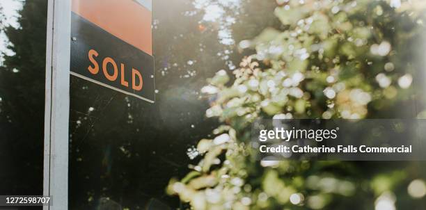 'sold' real estate sign outside a property - house for sale uk stock pictures, royalty-free photos & images