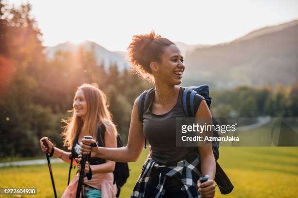 candid portrait of female friends hiking in jezersko valley - active lifestyle stock pictures, royalty-free photos & images