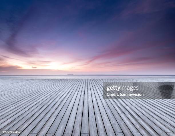 wooden parking lot against seaside during sunset - park dusk stock pictures, royalty-free photos & images