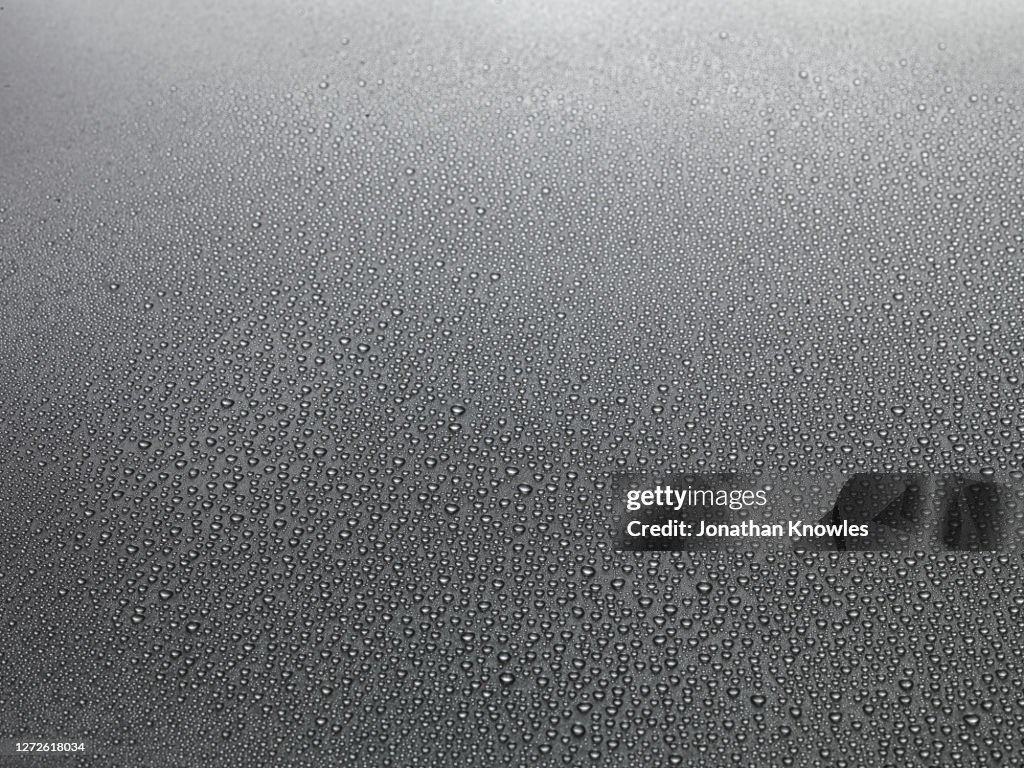 Water droplets on gray surface