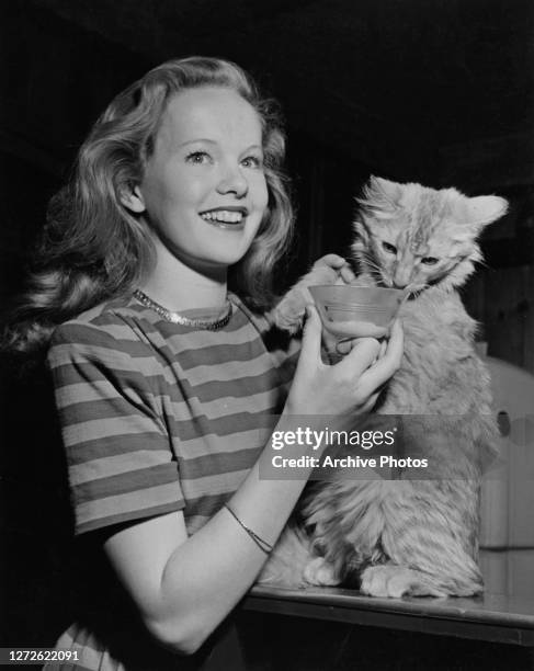 Irish actress Peggy Cummins with Cat Timmy, March 1947.