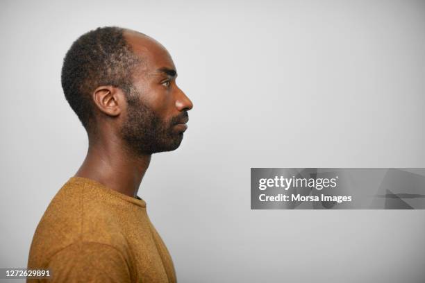 side view of serious african man on white background - man side view stock pictures, royalty-free photos & images