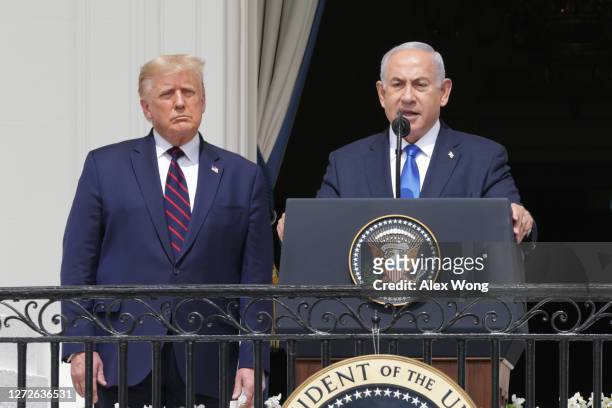 Prime Minister of Israel Benjamin Netanyahu speaks as U.S. President Donald Trump looks on during the signing ceremony of the Abraham Accords on the...