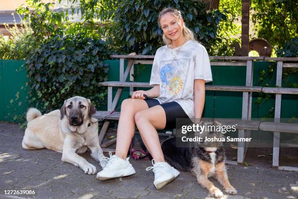 Cheyenne Pahde poses with the dogs Bella and Lupo during a photocall at animal shelter Dellbrueck on September 15, 2020 in Cologne, Germany.