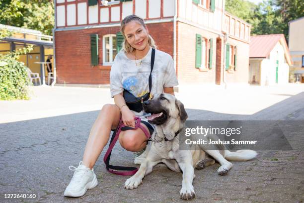 Cheyenne Pahde poses with dog Bella during a photocall at animal shelter Dellbrueck on September 15, 2020 in Cologne, Germany.