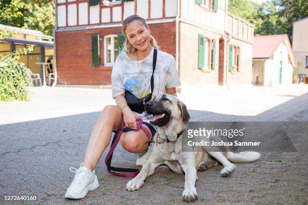 Cheyenne Pahde poses with dog Bella during a photocall at animal shelter Dellbrueck on September 15, 2020 in Cologne, Germany.