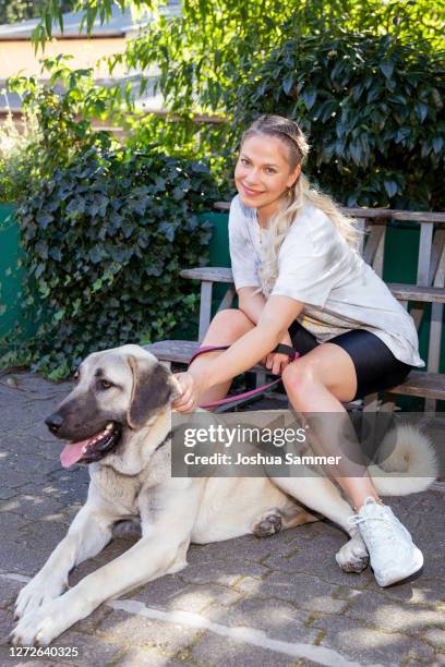 Cheyenne Pahde poses with dog Bella during a photocall at animal shelter Dellbrueck on September 15, 2020 in Cologne, Germany.