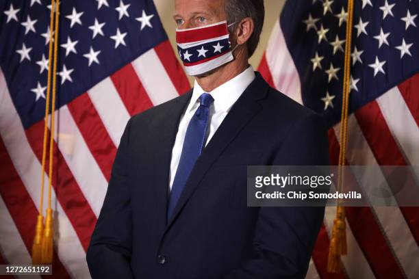Sen. John Thune wears a face mask to reduce the risk posed by the coronavirus following the weekly Republican policy luncheon in the Hart Senate...