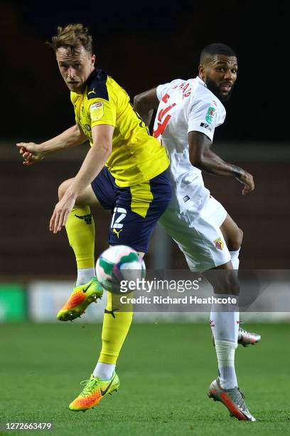 Jerome Sinclair of Watford battles for possession with Sam Long of Oxford United during the Carabao Cup Second Round match between Oxford United and...