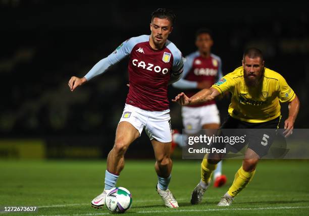 Jack Grealish of Aston Villa and Michael Bostwick of Burton Albion battle for the ball during the Carabao Cup Second Round match between Burton...