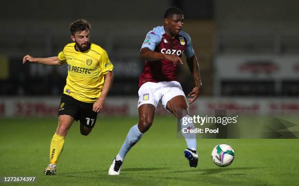 Steven Lawless of Burton Albion and Kortney Hause of Aston Villa battle for the ball during the Carabao Cup Second Round match between Burton Albion...