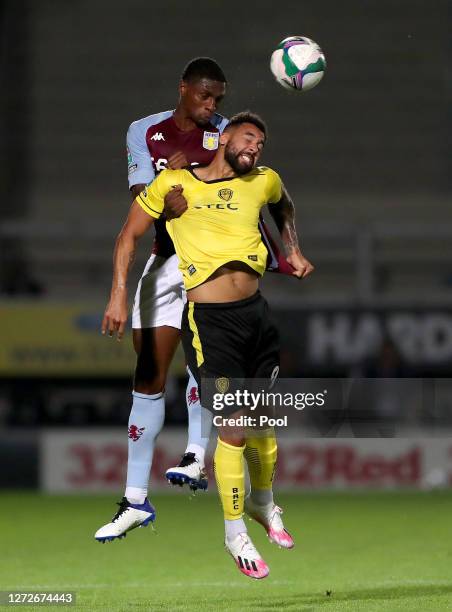 Kortney Hause of Aston Villa and Kane Hemmings of Burton Albion battle for the ball during the Carabao Cup Second Round match between Burton Albion...