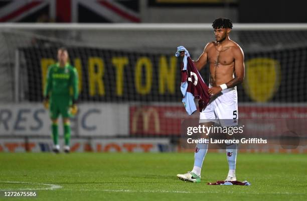 Tyrone Mings of Aston Villa changes his shirt during the Carabao Cup Second Round match between Burton Albion and Aston Villa at Pirelli Stadium on...