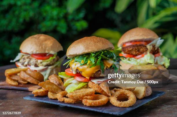 close-up of burgers on table, india - junk food foto e immagini stock