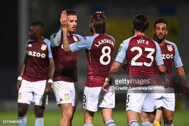 Jack Grealish of Aston Villa celebrates with teammates after scoring his team's second goal during the Carabao Cup Second Round match between Burton...