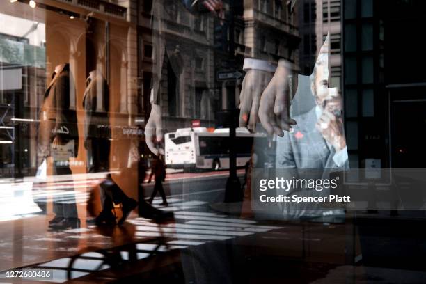 Men's business attire is displayed in the window of a Manhattan clothier on September 15, 2020 in New York City. With millions of Americans currently...