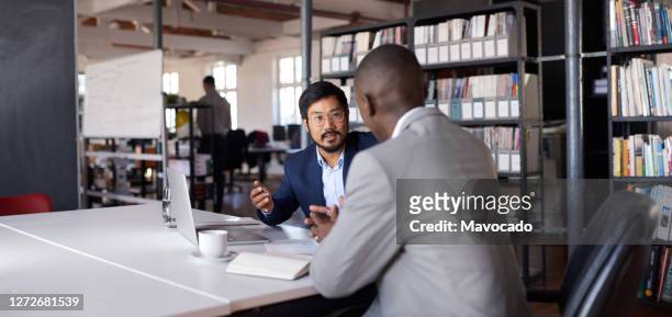 young asian businessman discussing work with a colleague - two people at computer stock pictures, royalty-free photos & images