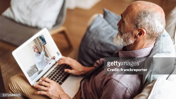 senior man teleconsulting with the doctor - effortless experience stock pictures, royalty-free photos & images