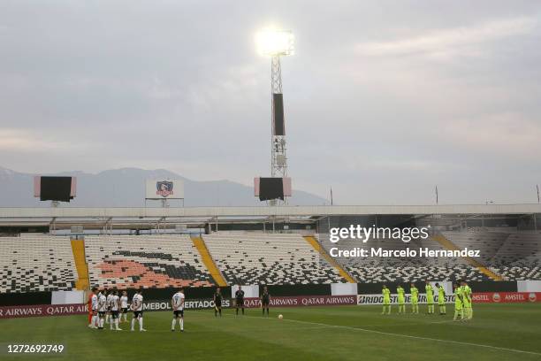 Players of Peñarol and Colo-Colo observe a minute of silence before a group C match between Colo Colo and Peñarol as part of Copa CONMEBOL...