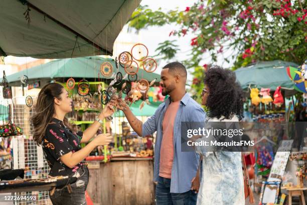 tourist couple looking at street crafts - latin america market stock pictures, royalty-free photos & images