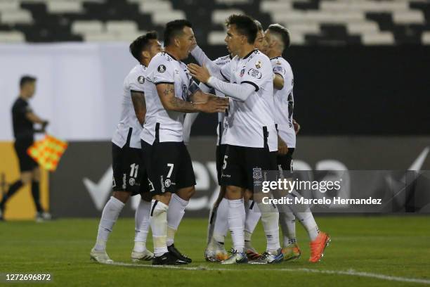 Esteban Paredes of Colo-Colo celebrates with teammates after scoring the second goal of his team on a penalty kick during a group C match between...