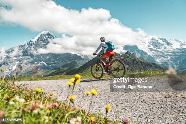 mountain biker on a ride trough sunny swiss alps - bernese alps stock pictures, royalty-free photos & images