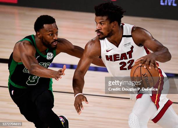 Jimmy Butler of the Miami Heat drives the ball against Kemba Walker of the Boston Celtics during the fourth quarter in Game One of the Eastern...