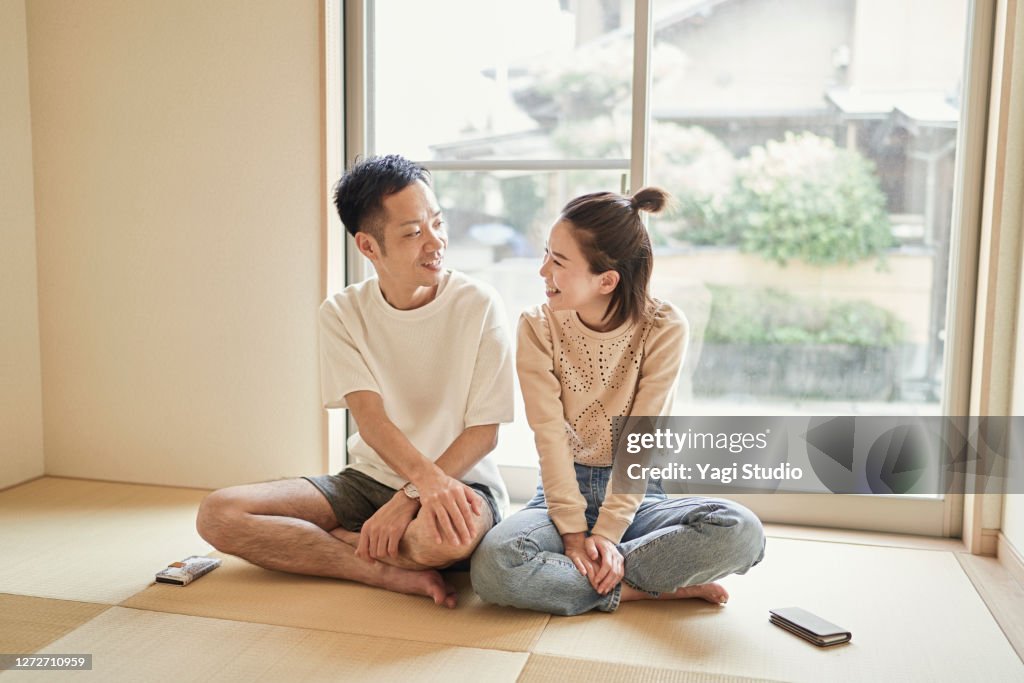 Asian couple relaxing in the Japanese-style room at home