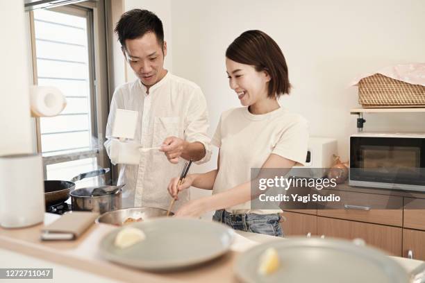 asian couple in preparing food in the kitchen - asian man cooking bildbanksfoton och bilder