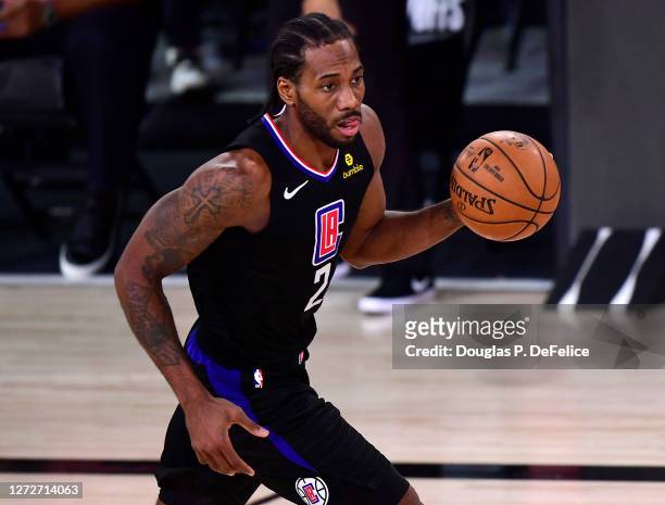 Kawhi Leonard of the LA Clippers of the LA Clippers dribbles the ball during the third quarter against the Denver Nuggets in Game Seven of the...