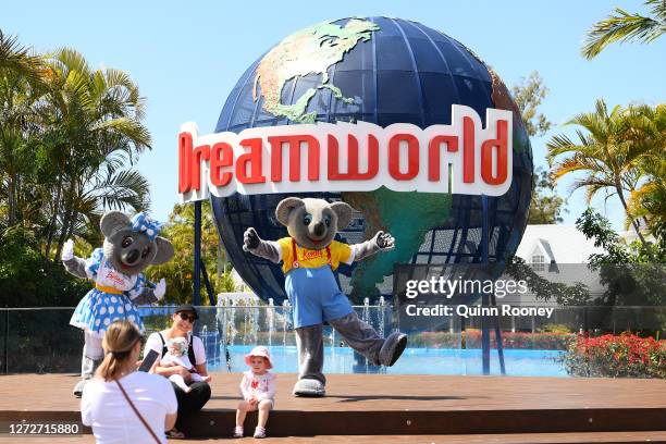 Patrons pose for a photo at the entrance of Dreamworld on September 16, 2020 in Gold Coast, Australia. Dreamworld and its sister park White Water...