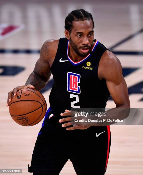 Kawhi Leonard of the LA Clippers dribbles the ball during the fourth quarter against the Denver Nuggets in Game Seven of the Western Conference...