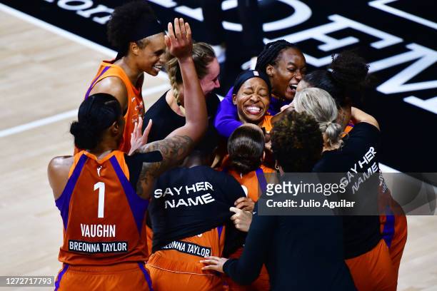 Shey Peddy of the Phoenix Mercury is surrounded by teammates after hitting a 3-point buzzer beater to defeat the Washington Mystics in Game One of...