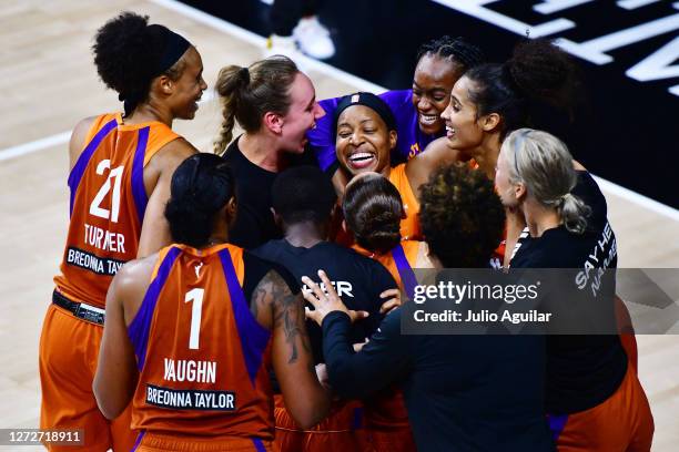 Shey Peddy of the Phoenix Mercury is surrounded by teammates after hitting a 3-point buzzer beater to defeat the Washington Mystics in Game One of...