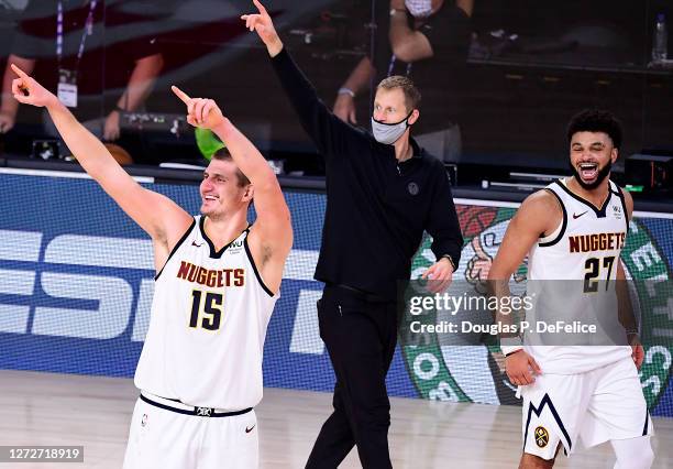 Michael Malone of the Denver Nuggets, Nikola Jokic of the Denver Nuggets and Jamal Murray of the Denver Nuggets celebrate their win over LA Clippers...