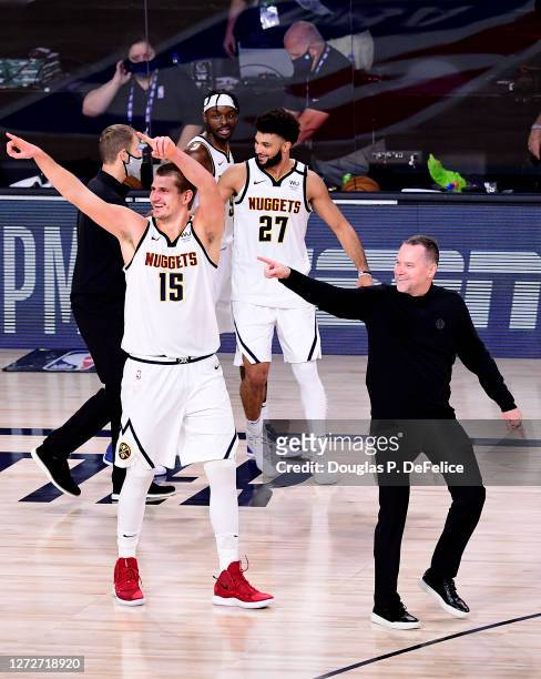 Michael Malone of the Denver Nuggets, Nikola Jokic of the Denver Nuggets and Jamal Murray of the Denver Nuggets celebrate their win over LA Clippers...
